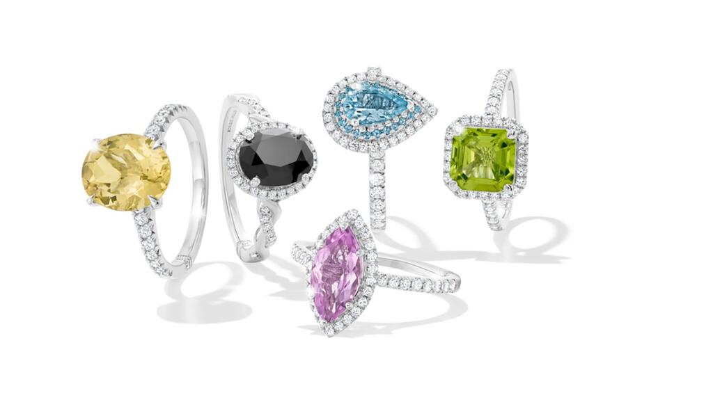 A selection of colorful engagement rings from Monique Lhuillier’s bridal collection at Kay Jewelers, which includes colored gemstones and black diamonds. Monique Lhuillier colored gemstone engagement rings